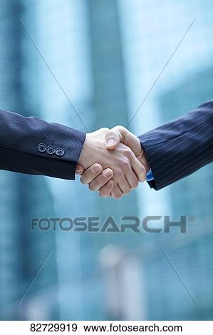 Japanese businesspeople shaking hands downtown Tokyo View Large Photo Image Stock Photo - Japanese businesspeople shaking hands downtown Tokyo. Fotosearch