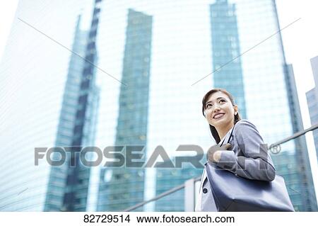 Picture - Japanese businesswoman downtown Tokyo. Fotosearch