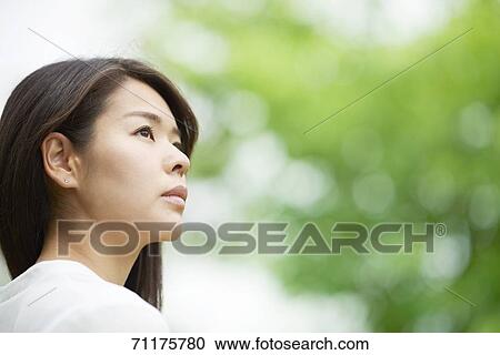 Stock Image - Japanese businesswoman downtown Tokyo. Fotosearch