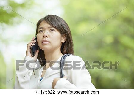 Stock Image - Japanese businesswoman downtown Tokyo. Fotosearch