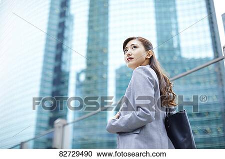 Stock Image - Japanese businesswoman downtown Tokyo. Fotosearch