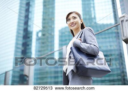 Stock Image - Japanese businesswoman downtown Tokyo. Fotosearch