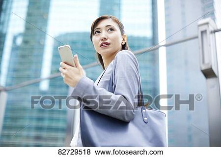 Stock Photo - Japanese businesswoman downtown Tokyo. Fotosearch