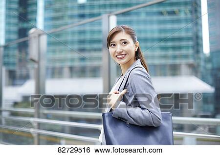 Stock Photograph - Japanese businesswoman downtown Tokyo. Fotosearch