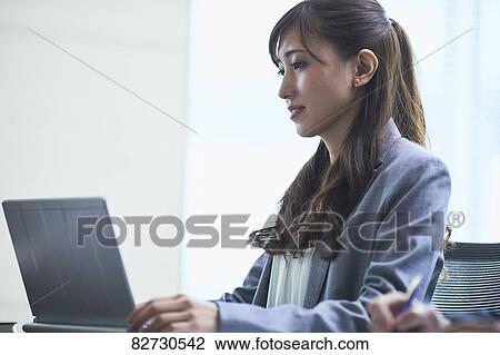 Japanese businesswoman in the office View Large Photo Image Stock Image - Japanese businesswoman in the office. Fotosearch