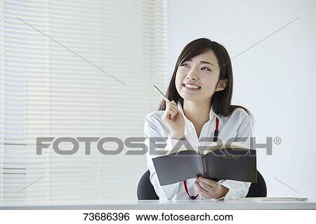 Japanese businesswoman in the office View Large Photo Image Stock Photograph - Japanese businesswoman in the office. Fotosearch