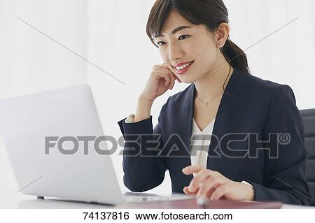 Japanese businesswoman in the office View Large Photo Image Stock Photograph - Japanese businesswoman in the office. Fotosearch