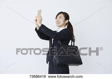 Stock Photograph - Japanese businesswoman on white background. Fotosearch