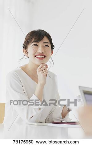 Stock Image - Japanese businesswoman working. Fotosearch