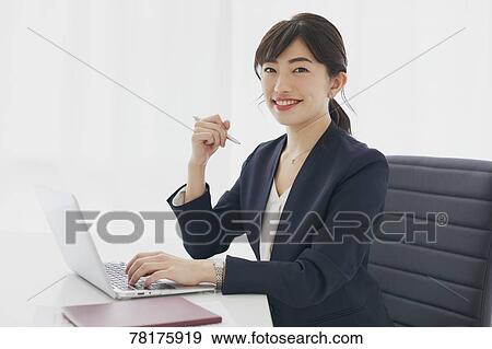 Stock Photo - Japanese businesswoman working. Fotosearch