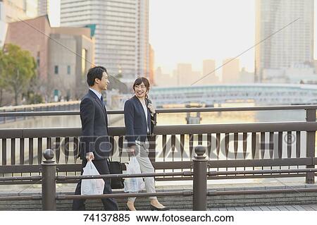 Stock Photography - Japanese couple commuting home from work. Fotosearch
