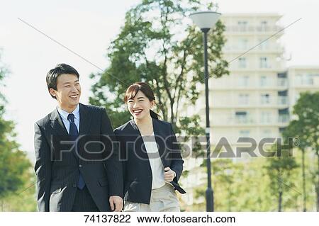 Stock Image - Japanese couple commuting to work. Fotosearch
