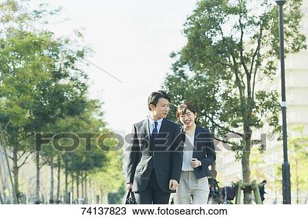 Stock Image - Japanese couple commuting to work. Fotosearch