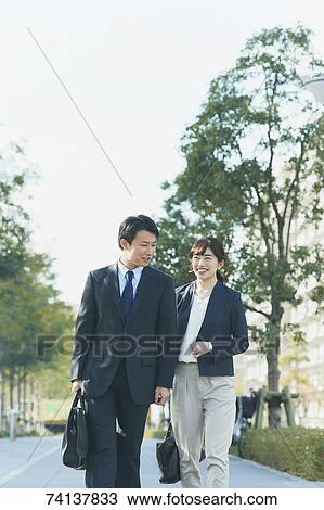 Japanese couple commuting to work View Large Photo Image Stock Image - Japanese couple commuting to work. Fotosearch
