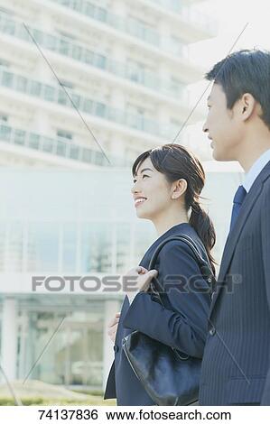 Japanese couple commuting to work View Large Photo Image Stock Photograph - Japanese couple commuting to work. Fotosearch
