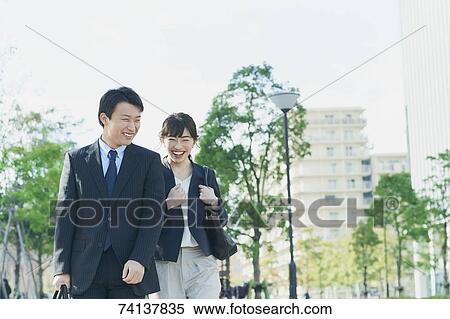 Japanese couple commuting to work View Large Photo Image Stock Photography - Japanese couple commuting to work. Fotosearch