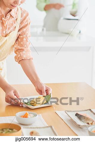 Japanese couple cooking together in the kitchen View Large Photo Image Picture - Japanese couple cooking together in the kitchen. Fotosearch
