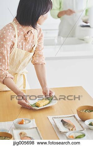 Japanese couple cooking together in the kitchen View Large Photo Image Stock Photo - Japanese couple cooking together in the kitchen. Fotosearch