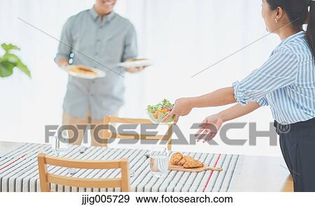 Japanese couple cooking together in the kitchen View Large Photo Image Stock Photo - Japanese couple cooking together in the kitchen. Fotosearch