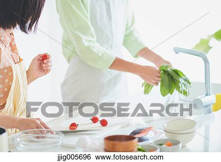 Japanese couple cooking together in the kitchen View Large Photo Image Stock Photograph - Japanese couple cooking together in the kitchen. Fotosearch