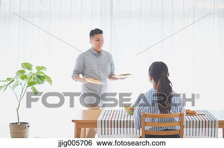 Japanese couple cooking together in the kitchen View Large Photo Image Stock Photograph - Japanese couple cooking together in the kitchen. Fotosearch