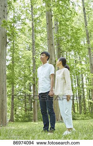 Picture - Japanese couple in a city park. Fotosearch