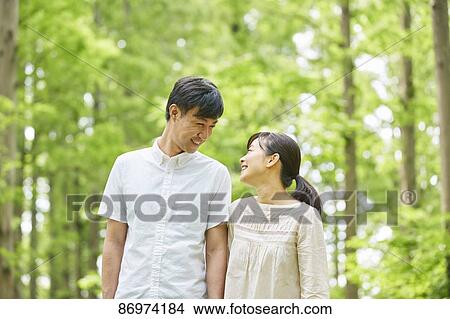 Picture - Japanese couple in a city park. Fotosearch