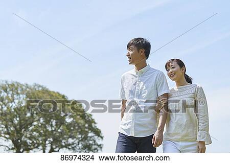 Japanese couple in a city park View Large Photo Image Picture - Japanese couple in a city park. Fotosearch