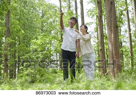 Japanese couple in a city park View Large Photo Image Stock Image - Japanese couple in a city park. Fotosearch