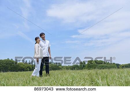 Japanese couple in a city park View Large Photo Image Stock Image - Japanese couple in a city park. Fotosearch