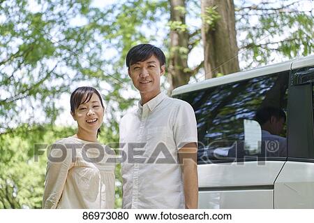 Japanese couple in a city park View Large Photo Image Stock Image - Japanese couple in a city park. Fotosearch