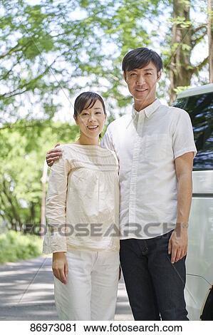 Japanese couple in a city park View Large Photo Image Stock Image - Japanese couple in a city park. Fotosearch