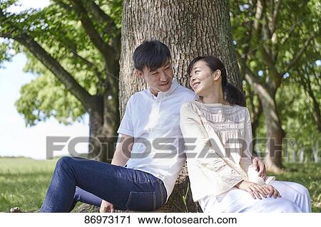 Japanese couple in a city park View Large Photo Image Stock Image - Japanese couple in a city park. Fotosearch