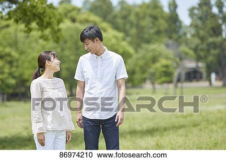 Japanese couple in a city park View Large Photo Image Stock Image - Japanese couple in a city park. Fotosearch