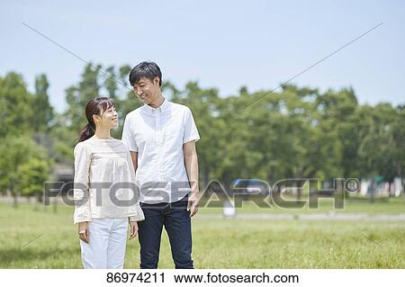 Japanese couple in a city park View Large Photo Image Stock Image - Japanese couple in a city park. Fotosearch
