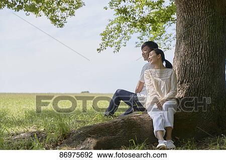 Japanese couple in a city park View Large Photo Image Stock Image - Japanese couple in a city park. Fotosearch