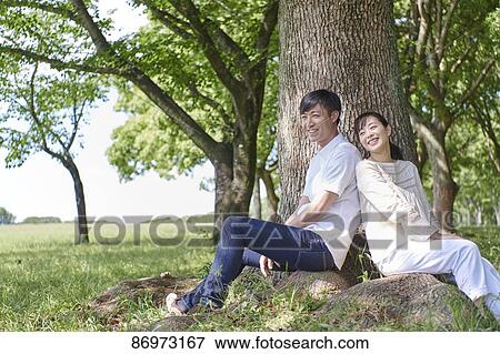 Japanese couple in a city park View Large Photo Image Stock Photo - Japanese couple in a city park. Fotosearch