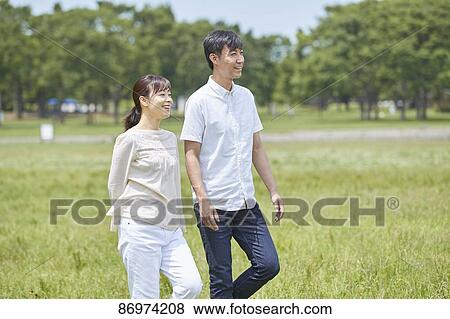 Stock Photo - Japanese couple in a city park. Fotosearch