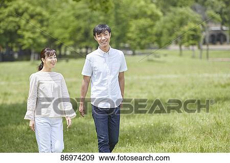 Japanese couple in a city park View Large Photo Image Stock Photo - Japanese couple in a city park. Fotosearch