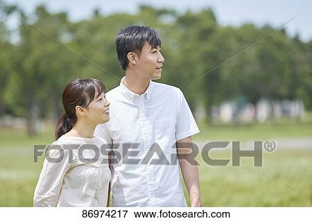 Japanese couple in a city park View Large Photo Image Stock Photo - Japanese couple in a city park. Fotosearch