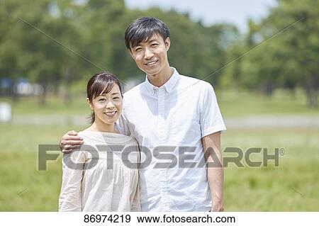 Stock Photo - Japanese couple in a city park. Fotosearch
