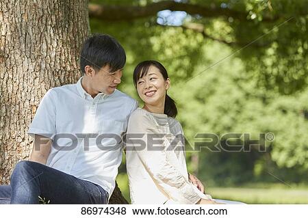 Japanese couple in a city park View Large Photo Image Stock Photo - Japanese couple in a city park. Fotosearch