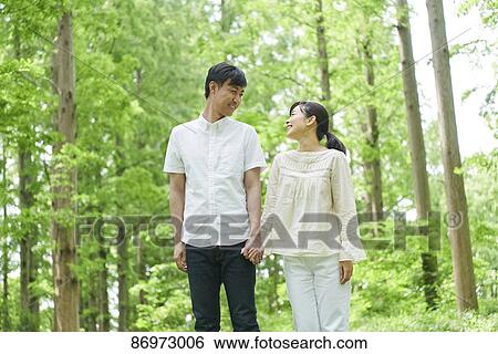Japanese couple in a city park View Large Photo Image Stock Photograph - Japanese couple in a city park. Fotosearch