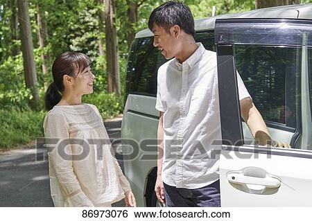Japanese couple in a city park View Large Photo Image Stock Photograph - Japanese couple in a city park. Fotosearch