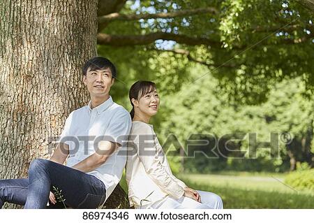 Japanese couple in a city park View Large Photo Image Stock Photograph - Japanese couple in a city park. Fotosearch