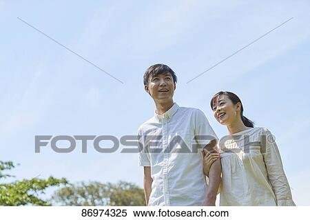Stock Photography - Japanese couple in a city park. Fotosearch