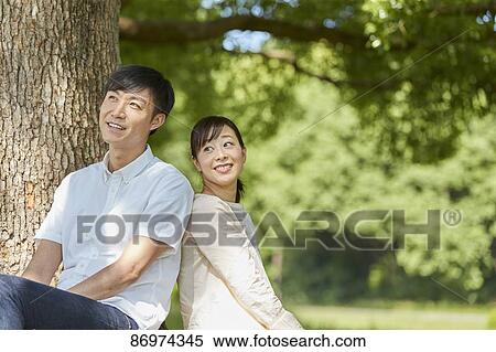 Japanese couple in a city park View Large Photo Image Stock Photography - Japanese couple in a city park. Fotosearch