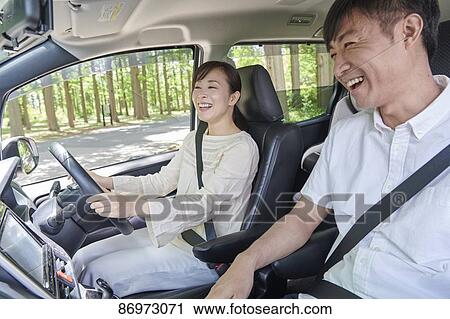 Stock Image - Japanese couple in the car. Fotosearch