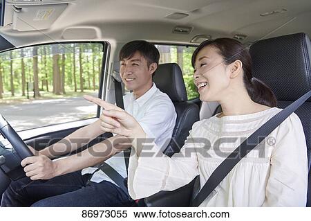 Stock Photography - Japanese couple in the car. Fotosearch