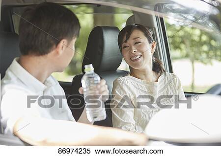 Stock Photography - Japanese couple in the car. Fotosearch